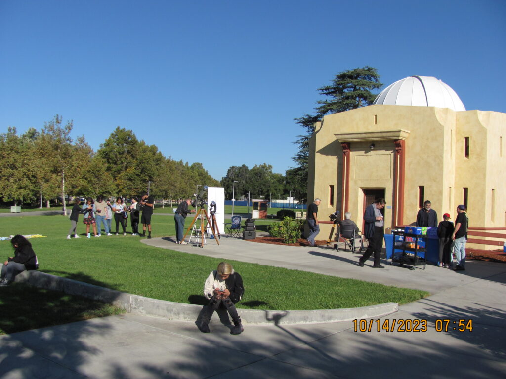 people sitting standing outside the san bernardino valley college observatory