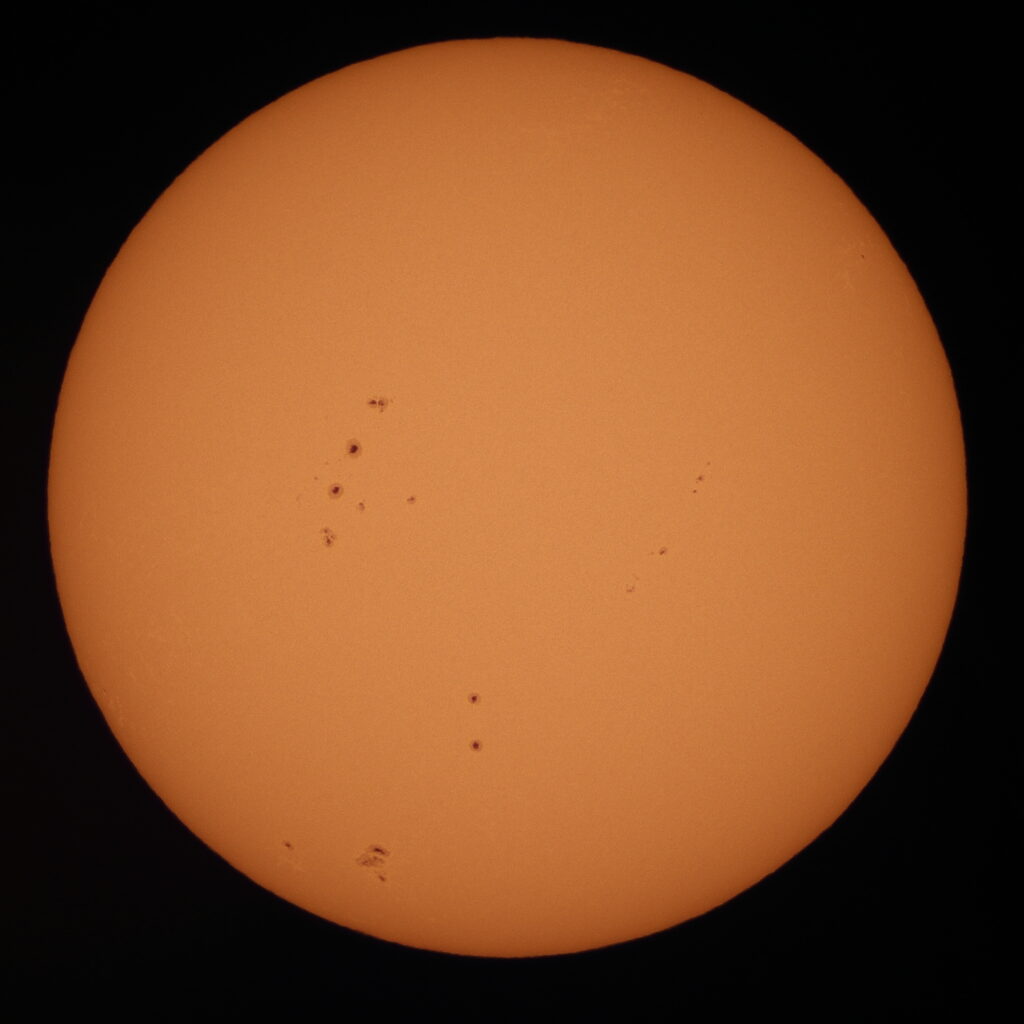 Telescopic image of the sun with many sunspots